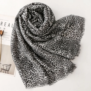 Leopard print cotton linen scarf with fine fringe edges displayed in a heart shape