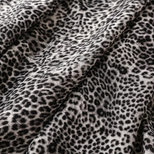 Close-up of leopard print cotton-linen scarf fabric showing detailed weave texture