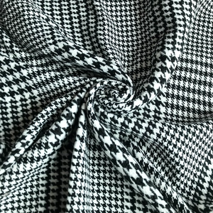 Classic black and white houndstooth cashmere poncho with a stylish split and tassel hem