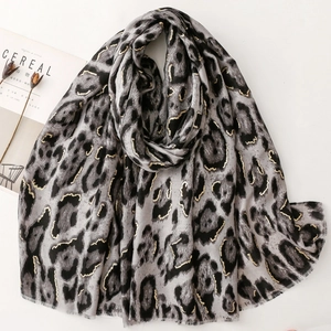 Classic leopard print scarf with gold foil accents and soft frayed edges for women