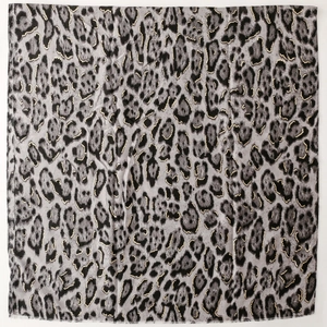 Detail of leopard print scarf featuring grey fabric with elegant gold foil edging accents