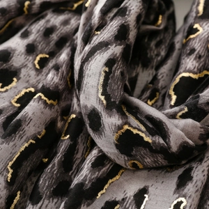 Detail of grey leopard print shawl with metallic gold foil accents and soft texture