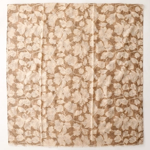 Detail of khaki cotton linen scarf with cream ginkgo leaf pattern and frayed edges