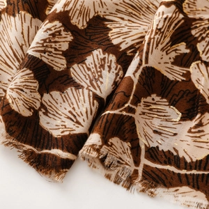 Detail of satin cotton scarf with gold ginkgo leaf foil print and frayed edges