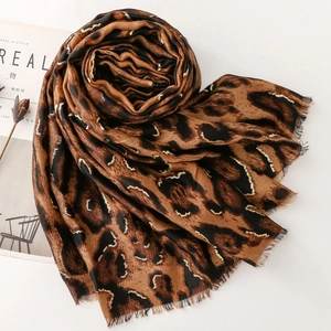 Close-up of leopard print scarf with soft texture and elegant frayed tassel edges