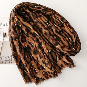 Macro shot of soft leopard print cotton-linen shawl featuring elegant frayed fringe edges