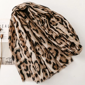 Detailed view of leopard print cotton linen scarf with soft fringe edges and fabric texture