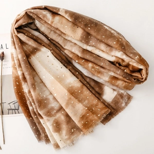 Detail of gradient cotton linen scarf with gold foil accents and soft fringe edges