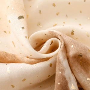 Close-up of soft cotton-linen scarf with gold heart foil and gradient ombre texture