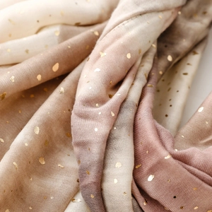 Detail of soft cotton linen scarf showing gold foil dots and elegant color gradient