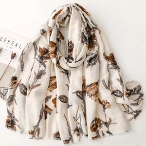 Elegant cotton linen scarf with bronze floral print and rustic frayed edges on white