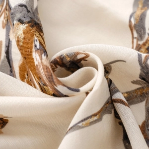Macro shot of cotton linen scarf with floral print and gold foil stamping detail