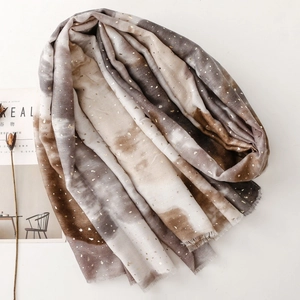 Detail of gradient cotton linen scarf with elegant gold stamping and fringed edges
