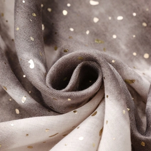 Close-up of soft cotton-linen scarf with gold foil accents and grey gradient texture