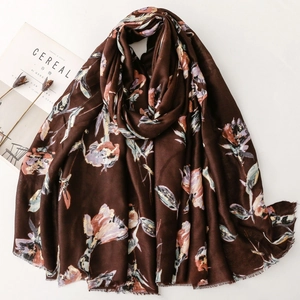 Macro detail of silk-like floral print scarf in dark coffee with soft fringe edges