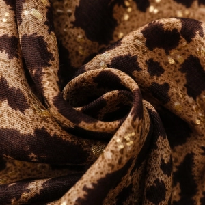 Detail of leopard print cotton linen scarf with metallic gold foil spots and fringe