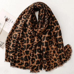 Detail of leopard print scarf with fringe edges and soft satin cotton texture