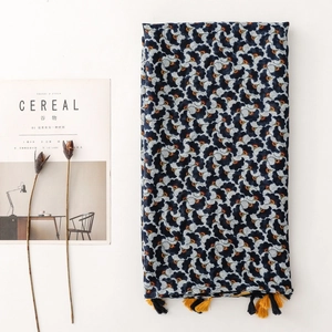 Bohemian navy blue scarf with ginkgo leaf print and tassel trim on white background