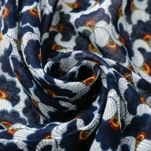 Macro detail of Bohemian linen-feel scarf with vintage navy blue floral and ginkgo leaf patterns