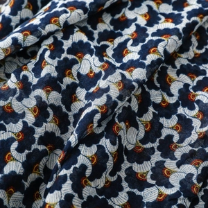 Detailed close-up of bohemian ginkgo leaf print on soft cotton linen scarf fabric