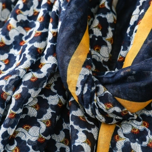 Macro detail of Bohemian linen-feel scarf showing navy blue and yellow floral patterns
