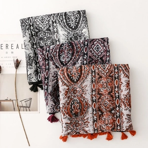 Detailed view of paisley cotton linen scarves with tassels and intricate ethnic patterns