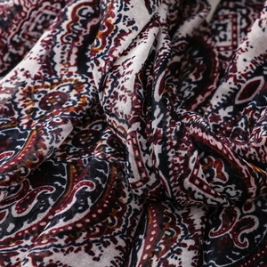 Detailed shot of Bohemian paisley pattern scarf with soft linen texture and fringe