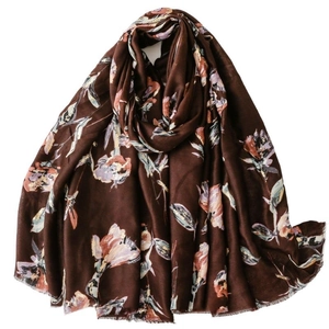 Floral print scarf with gold foil accents on dark brown soft textured fabric shawl