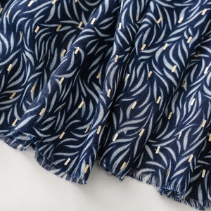 Detail of navy cotton linen scarf with gold foil accents and soft frayed edges