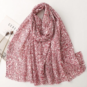 Soft cotton linen scarf with red feather print and gold glitter accents on white base