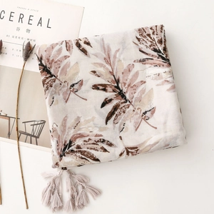 Detail view of retro leaf print scarf with tassels on ivory cotton linen fabric