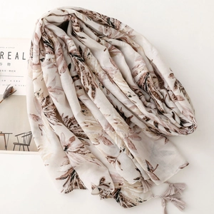Elegant off-white leaf print shawl with delicate tassels and a soft linen-like texture