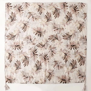 Off-white cotton linen scarf with brown leaf prints and tassels on white background