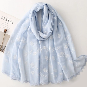 Écharpe bleu clair avec broderie florale, roses blanches et bords en dentelle