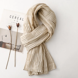 Macro detail of beige pleated texture scarf with soft aesthetic wrinkles for autumn