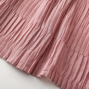 Macro shot of vertical pleated texture on dusty rose autumn winter soft scarf fabric