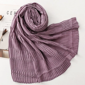 Detailed close-up of dark purple pleated scarf with a soft crinkled texture for winter