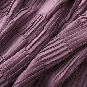 Macro detail of dark purple pleated texture on soft, lightweight autumn winter scarf fabric