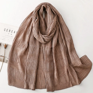 Detailed texture of brown pleated scarf with vertical creases on minimalist background