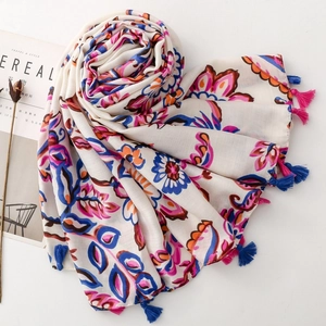 Close-up of bohemian floral scarf with colorful handmade tassels and soft fabric