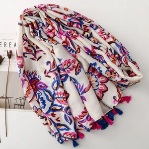 Ethnic floral print scarf with tassels on white background with cereal magazine lifestyle