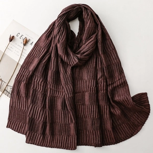 Macro detail of dark coffee pleated scarf with textured fabric and elegant accordion folds