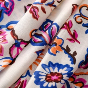 Close-up of bohemian floral print fabric with artistic patterns and soft drape texture