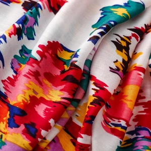 Close-up of artistic abstract floral print scarf fabric with soft texture and vibrant colors