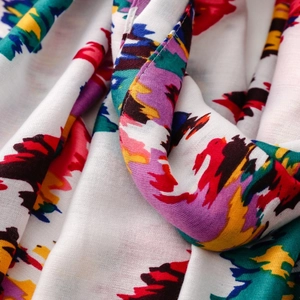 Macro detail of colorful abstract graffiti print on soft warm fabric scarf with tassels