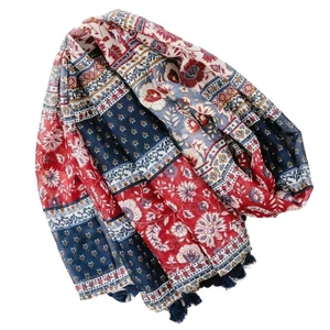Ethnic style floral scarf with geometric patterns and fringe tassels on a white background