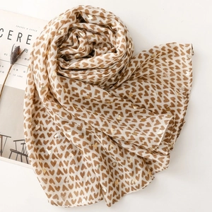 Detail of heart print scarf with gold foil accents and lightweight translucent fabric
