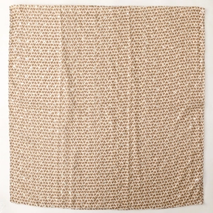 Close-up of heart pattern print on beige satin silk scarf with soft draped texture