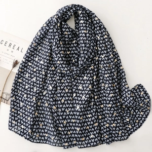 Detail of dark blue scarf with gold foil heart prints and soft satin texture fabric