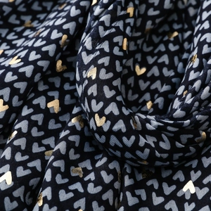 Detail of navy scarf showing grey elephant heart pattern and golden foil heart prints